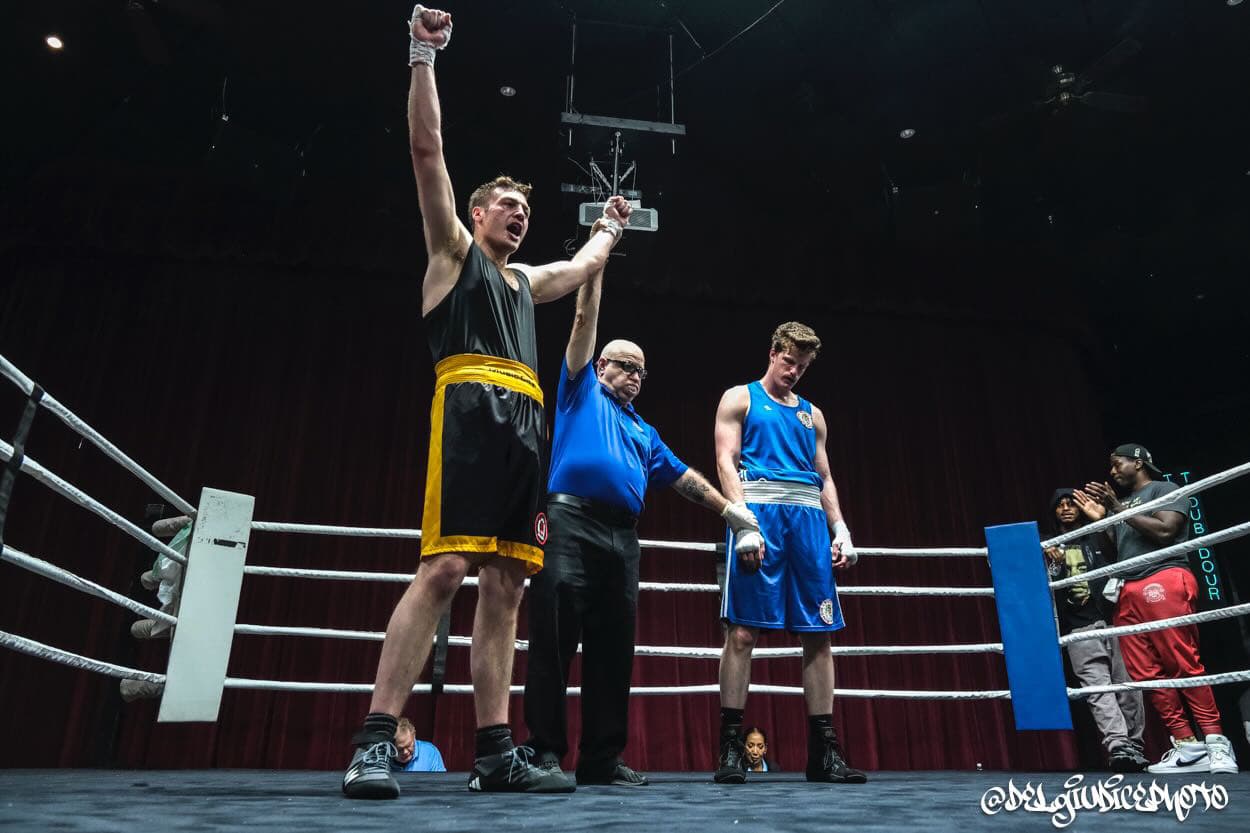 Amateur boxer's hand raised in victory at a Music City Boxing event in Nashville