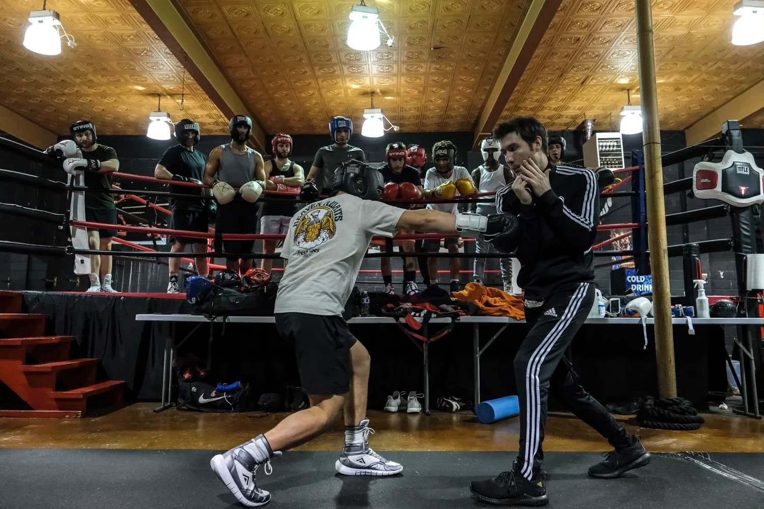 Coach holding mitts during Music City Boxing team training session in Nashville